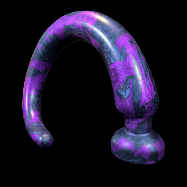 Curved purple and blue dildo on black background