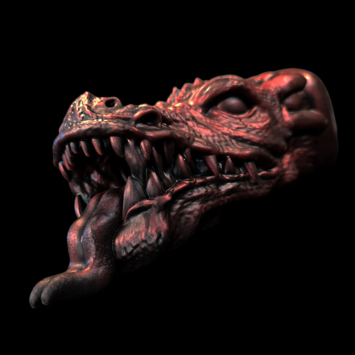 Metallic dragon head sex toy for men on a black background