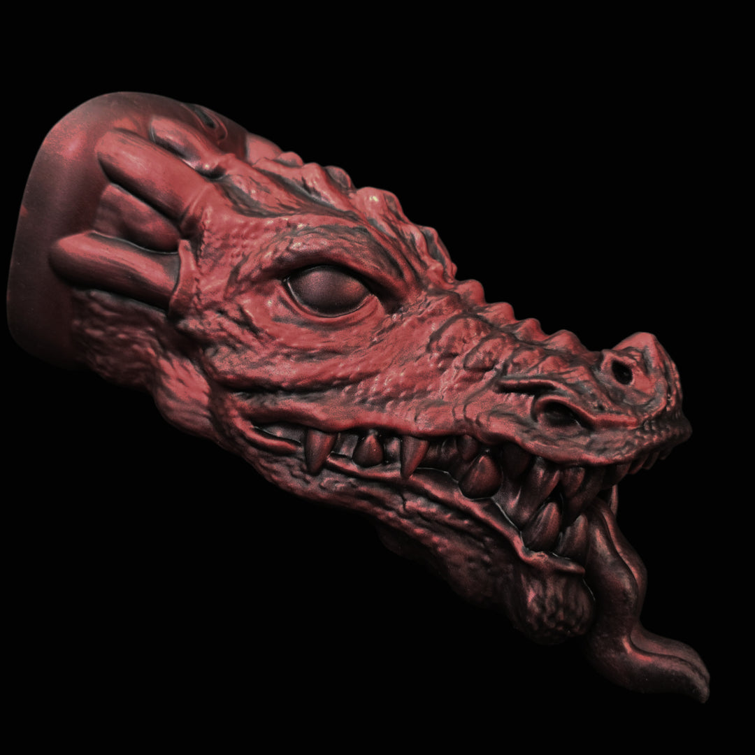 Red dragon head penetrable sex toy sculpture on a black background