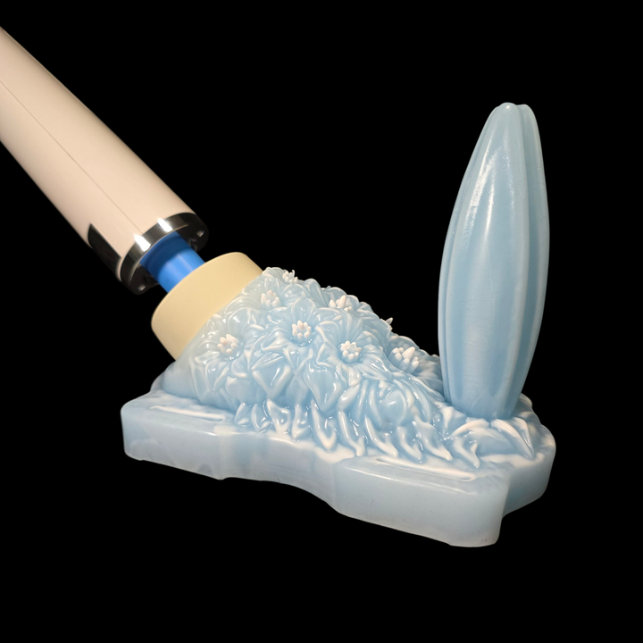 Massage wand going into a grinder sex toy on a black background