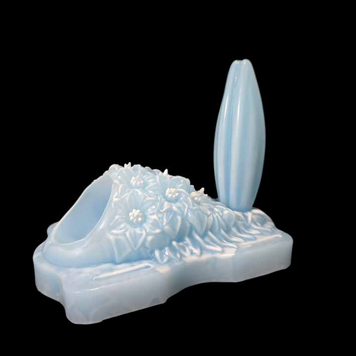 Massage wand cavity on a grinder sex toy with floral pattern on a black background