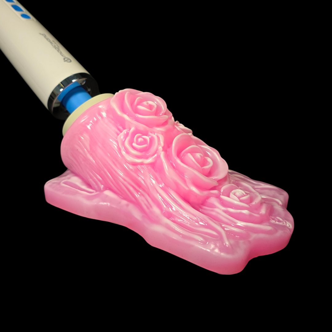 Pink floral design on a white and blue object against a black background