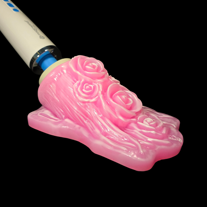 Pink floral design on a white and blue object against a black background