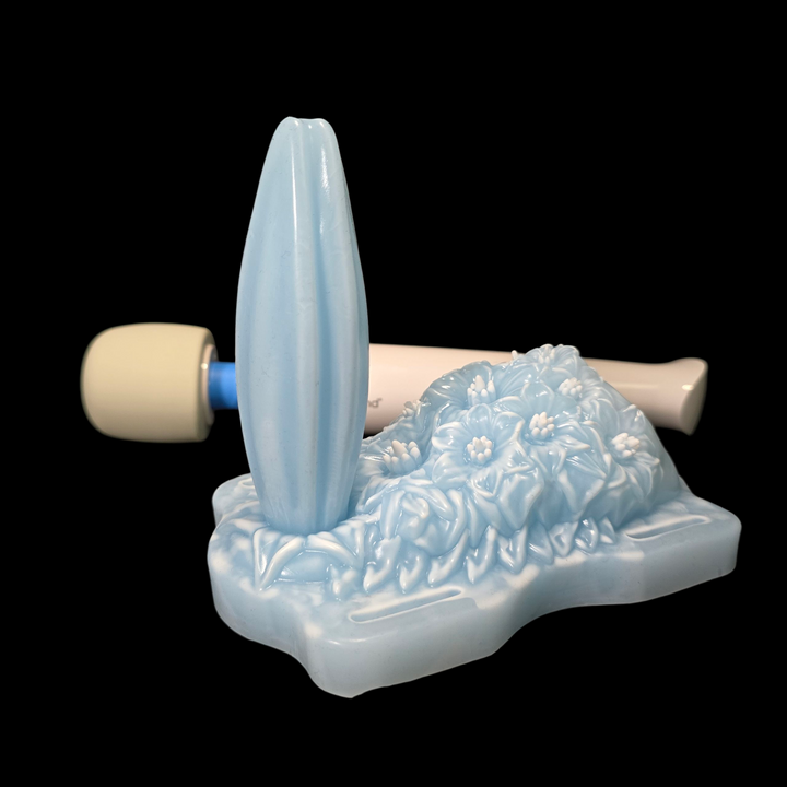 Decorative blue and white object with floral patterns on a black background
