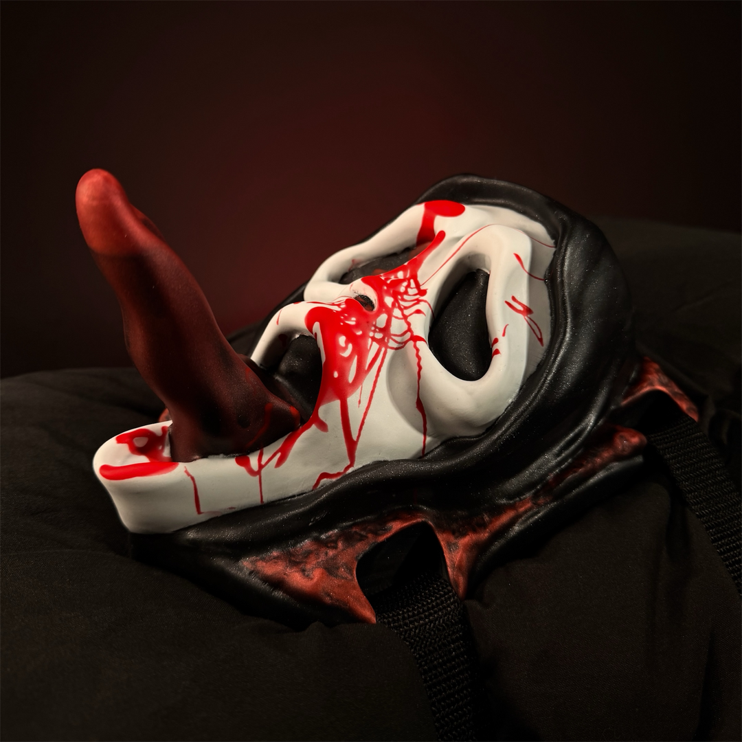 The Slasher insertable wand grinder with masked face and silicone tongue