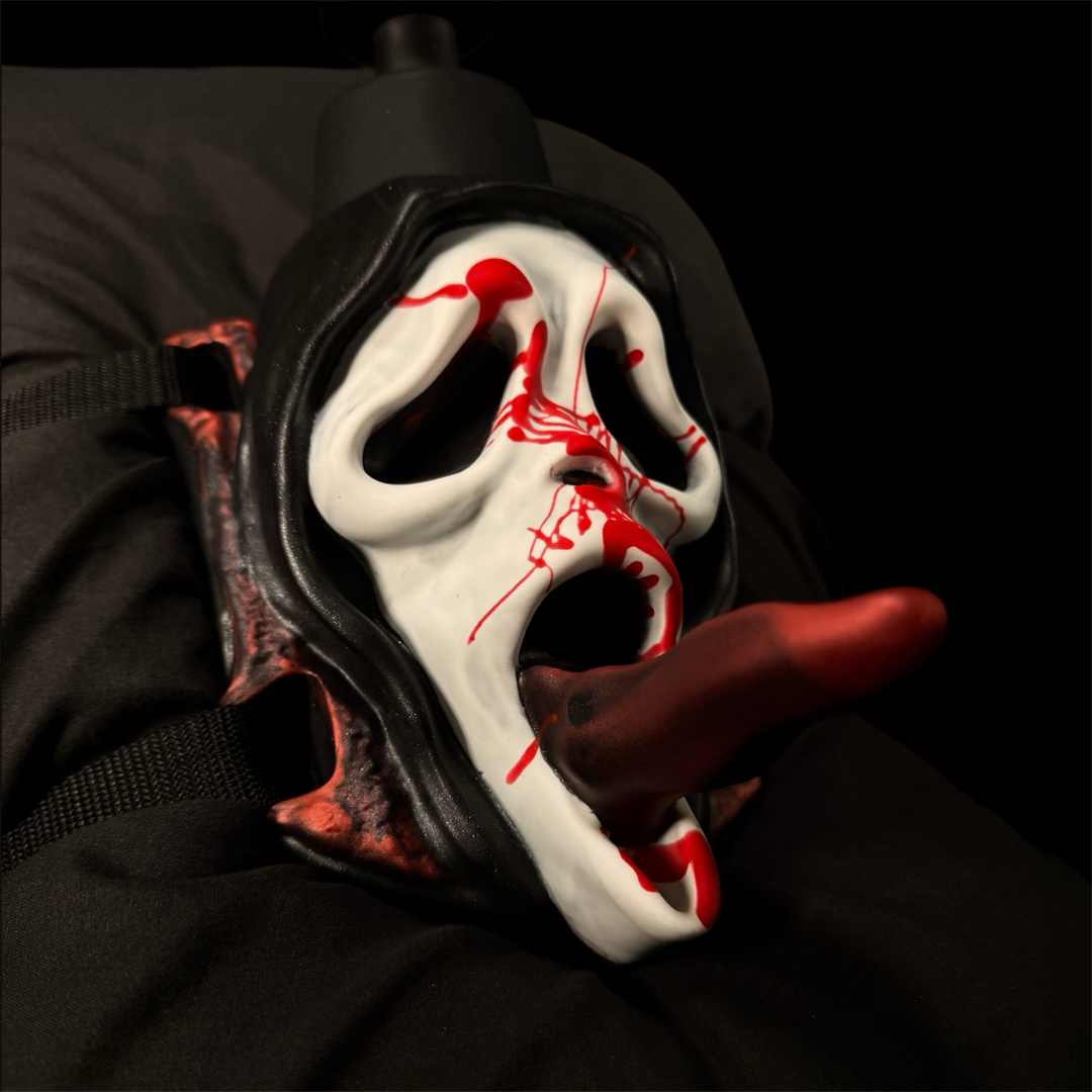 Front view of The Slasher wand grinder with blood-spattered white mask and black hood